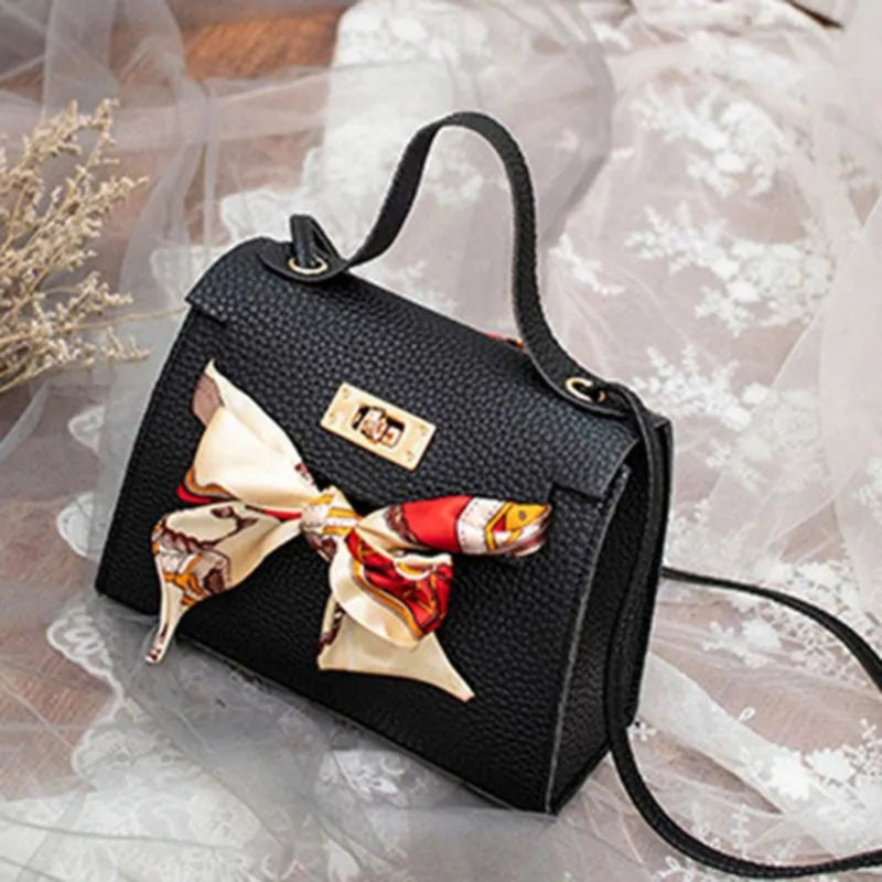 Leather handbag with scarf for an elegant and stylish look.