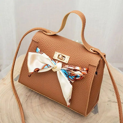 Leather handbag with scarf for an elegant and stylish look.