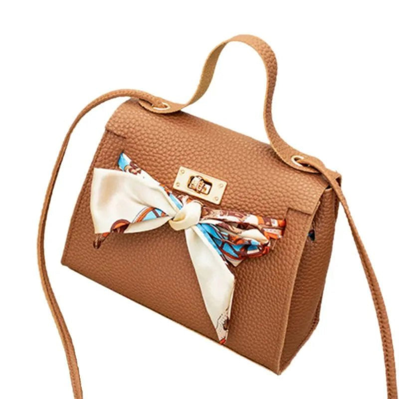 Leather handbag with scarf for an elegant and stylish look.