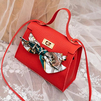 Leather handbag with scarf for an elegant and stylish look.